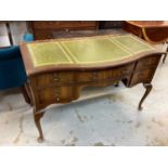 Walnut veneered serpentine fronted kneehole writing table with inset leather lined top, five drawers