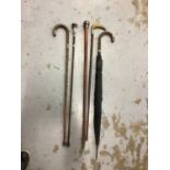 Four silver mounted walking canes/sticks and an umbrella (5)