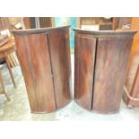 Two George III mahogany bowfront corner cupboards