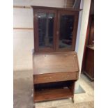 Early 20th century walnut two height escritoire with two glazed doors above, writing compartment, si
