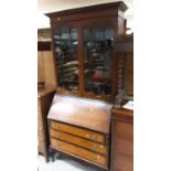 1920's mahogany two height bureau bookcase with shelves above enclosed by two glazed doors, writing