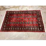 Three Eastern rugs with geometric decoration on red ground, 149cm x 96cm