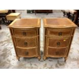 Pair of good quality three drawer bedside chests with crossbanded decoration on turned legs, bearing