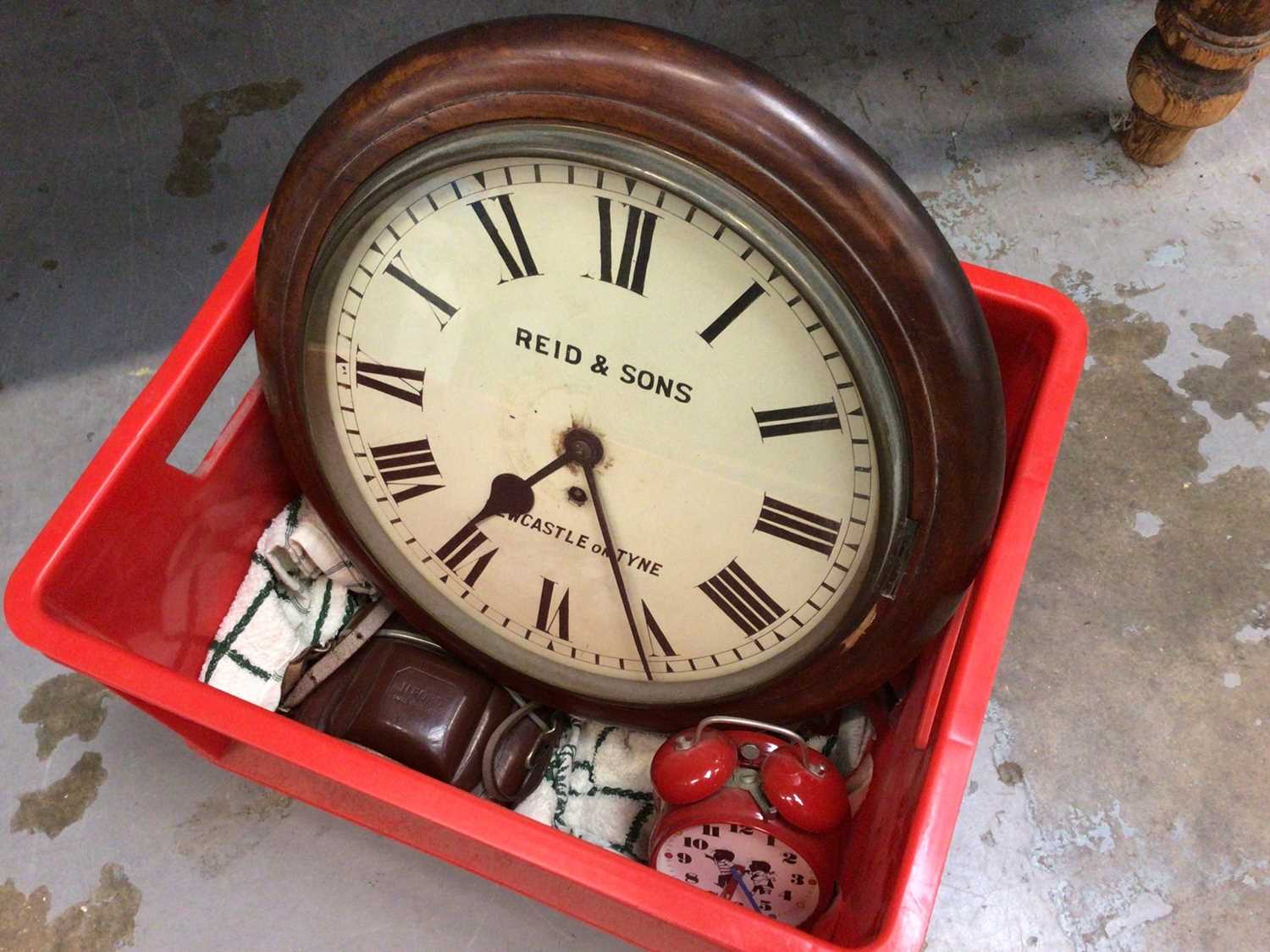 A Reid & Sons Newcastle on Tyne cased wall clock, with an alarm clock and a camera