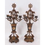 Pair of 19th century Continental gilt metal and painted porcelain four branch candlesticks, with scr