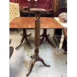 Victorian mahogany torchere with circular top and spiral receded column on three hipped splayed legs