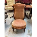 Victorian mahogany framed nursing chair with peach upholstery on fluted turned front legs and cerami