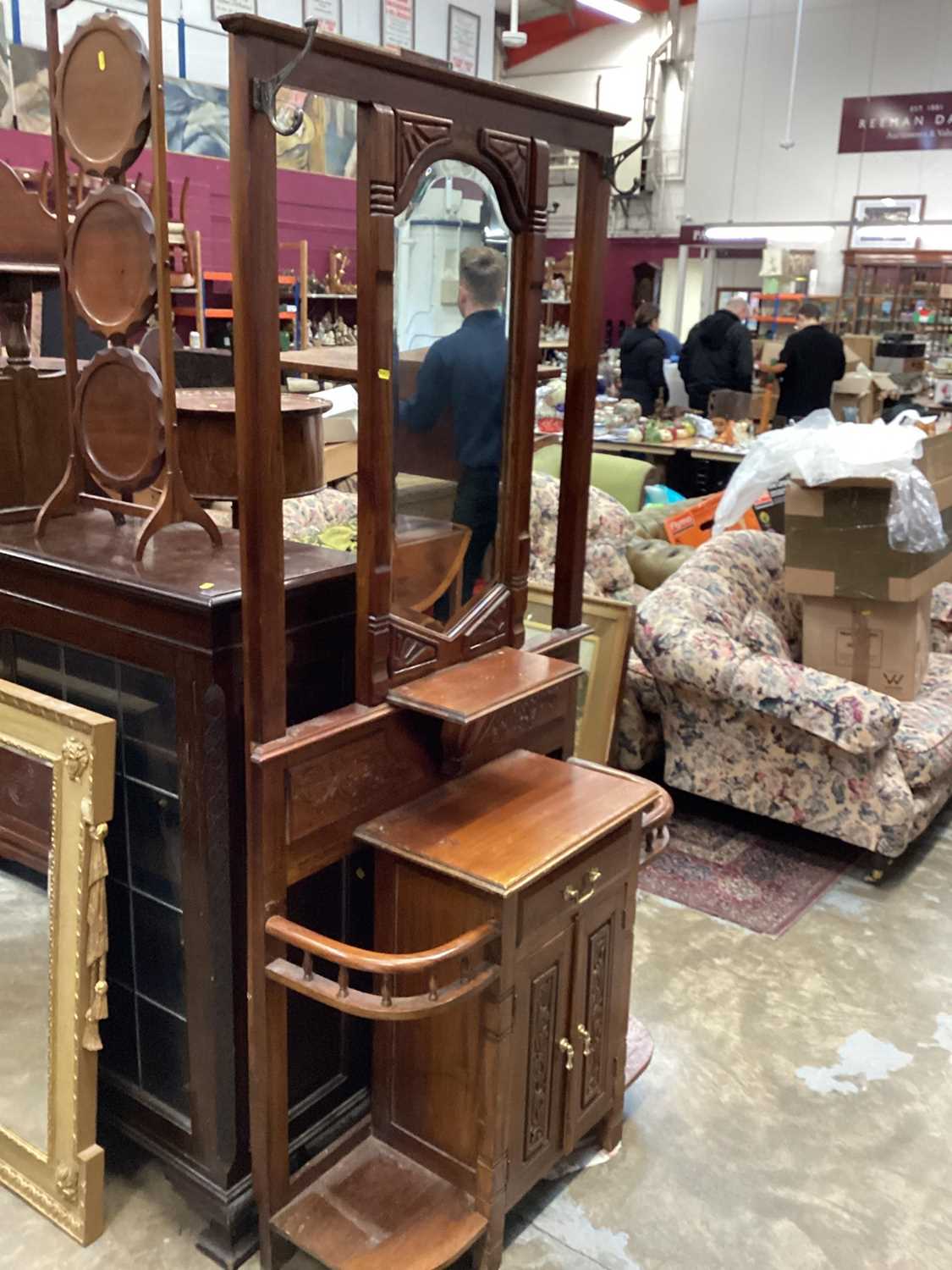 Edwardian walnut hall stand with bevelled mirror back, drawer and cupboards below with carved decora