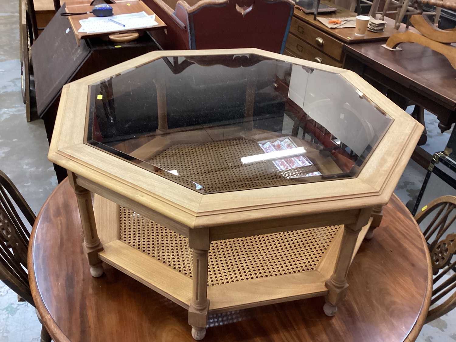 Octagonal coffee table with glass top on turned and block legs with caned undertier, 97cm wide, 43cm