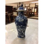 A Chinese blue and white porcelain baluster vase and cover, circa 1900, decorated with prunus blosso