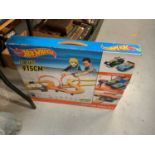 One box of mixed books and a Hot Wheels track