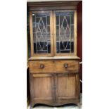 George III mahogany and ebony line inlaid secretaire bookcase, the upper section enclosed by pair of