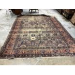 Large Eastern rug with geometric decoration on red and blue ground, 322cm x 230cm