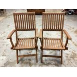 Set of six good quality teak folding garden chairs with loose cushions, bearing label Robert Dyas