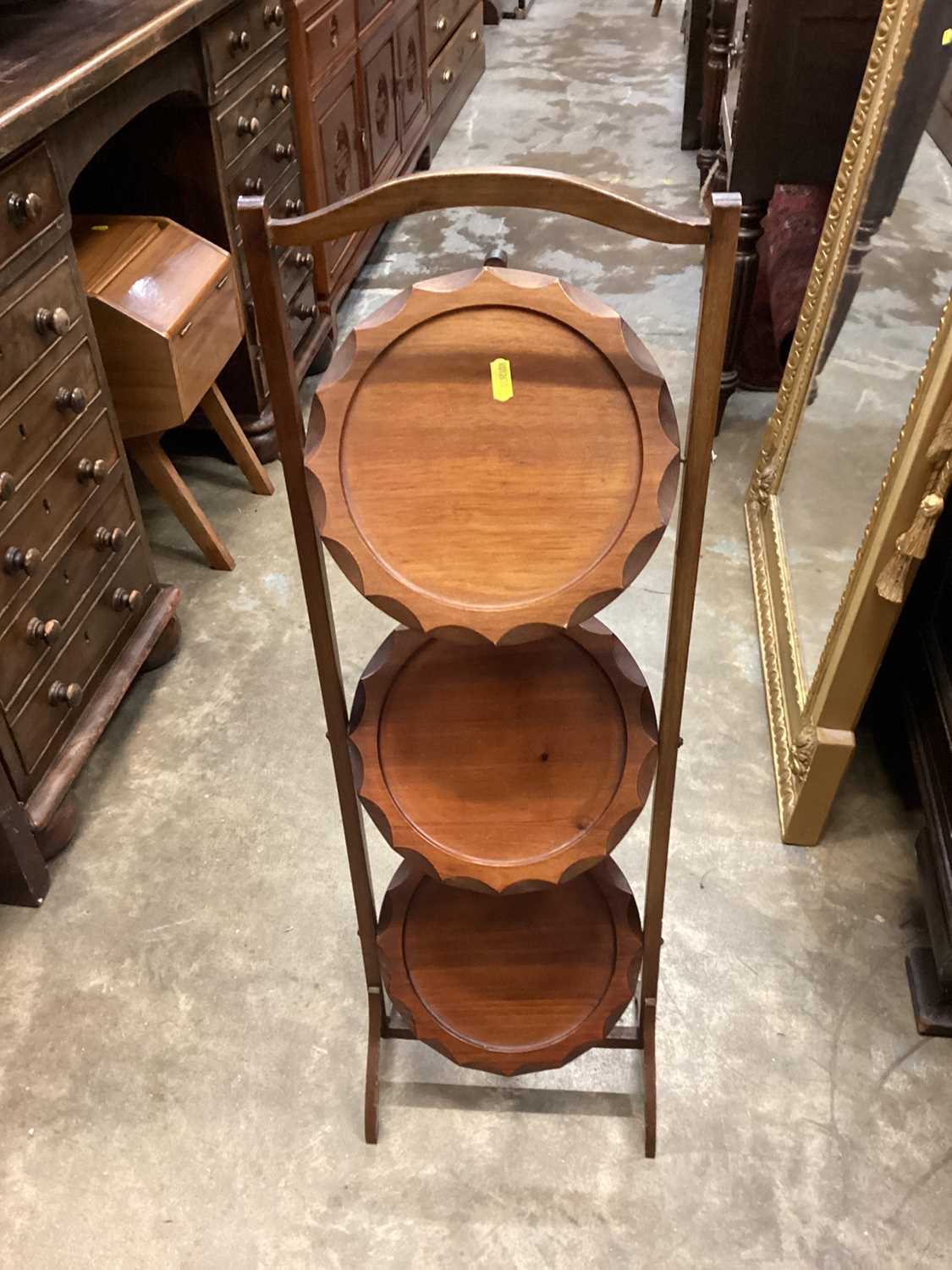 Three tier folding cake stand together with an oak occasional table with magazine rack undertier and