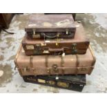 Four vintage luggage and cabin trunks