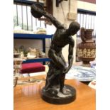 A Grand Tour style bronzed figure of a discus thrower, on a circular base