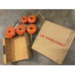 Graduated set of five Le Creuset lidded saucepans, with hanging shelf, boxed