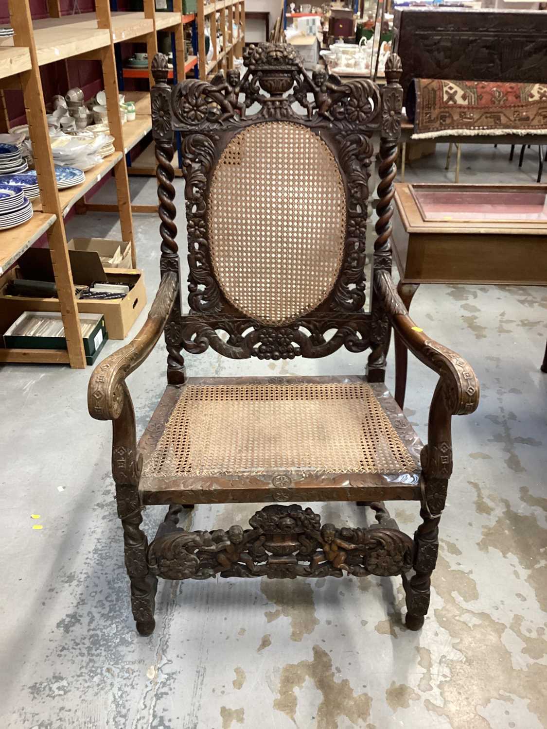 Late Victorian heavily carved oak elbow chair with cane seat and back, and spiral twist supports, 68