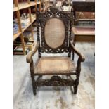 Late Victorian heavily carved oak elbow chair with cane seat and back, and spiral twist supports, 68