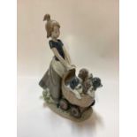 Three Lladro porcelain figure groups - girl with pram full of puppies 5364, girl with dog 5688 and g