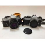 Nikon FG 35mm SLR camera with 50mm f/1.8 lens, and a Nikon FE body