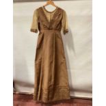 Edwardian ladies outfit in brown taffeta silk. High waist dress with ruffled and pleated trims, fla