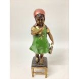 A painted bronze figure of a girl standing on a stool, 14½" high