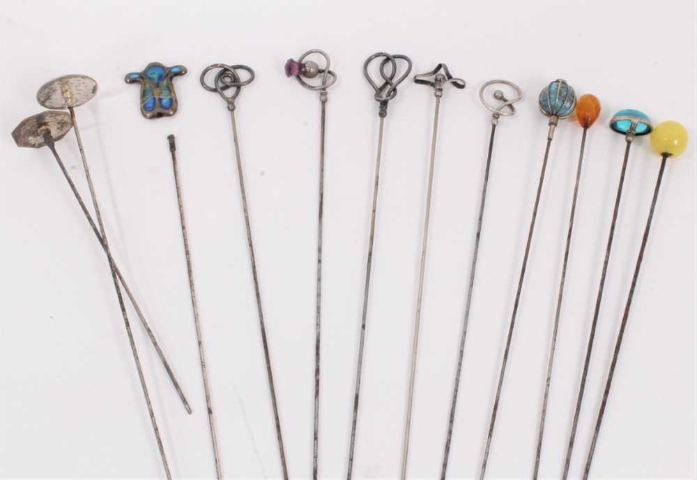 Collection of twelve vintage hat pins including five silver pins by Charles Horner, three enamelled