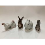 Three Royal Copenhagen porcelain models of Rabbits number 4705, 578 and 1019 together with a Squirre