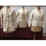 Three vintage white linen work/chore jackets plus a similar coat and white cotton jacket.