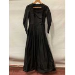 Victorian black dress with flat front opening, pleated skirt with buttoned hem and leg of mutton sle