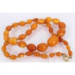 Butterscotch amber graduated bead necklace with oval polished beads, the largest measuring 15mm x 10