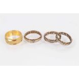 Two 9ct gold gem set eternity rings, one other similar 9ct gold and silver ring and a Japanese yello