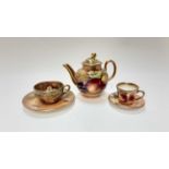 Miniature Royal Worcester teapot with hand painted fruit study signed J. Sherratt, together with mat
