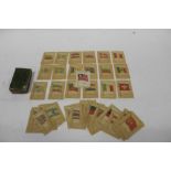 A box containing Kensitas silk flag cigarette cards