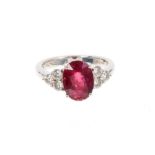 Pink tourmaline and diamond ring with an oval mixed cut pink tourmaline weighing approximately 3.29c