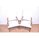 Pair of Continental Carolean style walnut open armchairs