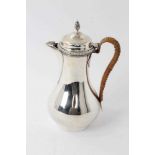 Edwardian Georgian-style silver hot water pot with caned handle