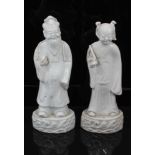 Pair of Chinese Qing period blanc de chine figures, the female figure carrying a fly whisk, the male