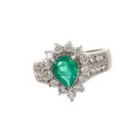 Emerald and diamond cluster ring with a pear cut emerald measuring approximately 8mm x 6mm surrounde