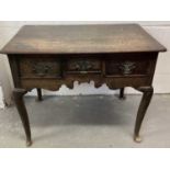 Mid 18th century oak lowboy, having three drawers over fretwork frieze, raised on cabriole legs and