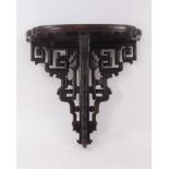 Late 19th/early 20th Chinese carved hardwood wall bracket, with geometric pierced supports, 34cm wid