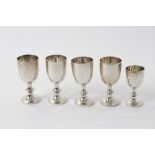 Four Edwardian silver egg cups with beaded collars
