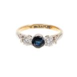 Sapphire and diamond three stone ring in platinum setting on 18ct yellow gold shank
