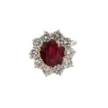 Ruby and diamond cluster ring with an oval mixed cut ruby measuring approximately 9.1mm x 8.3mm x 6.