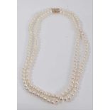 Cultured pearl two-strand opera length necklace with a 14ct gold and diamond clasp