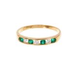 Emerald and diamond eternity ring with three brilliant cut diamonds interspaced by four round mixed