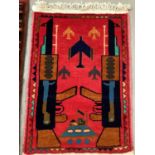 Two 1970s Afghan political rugs with war motifs, approximately 98cm x 65cm.