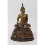 Tibetan gilded bronze Buddha figure, depicted in serene pose raised on stepped lappet base, 30cm hig